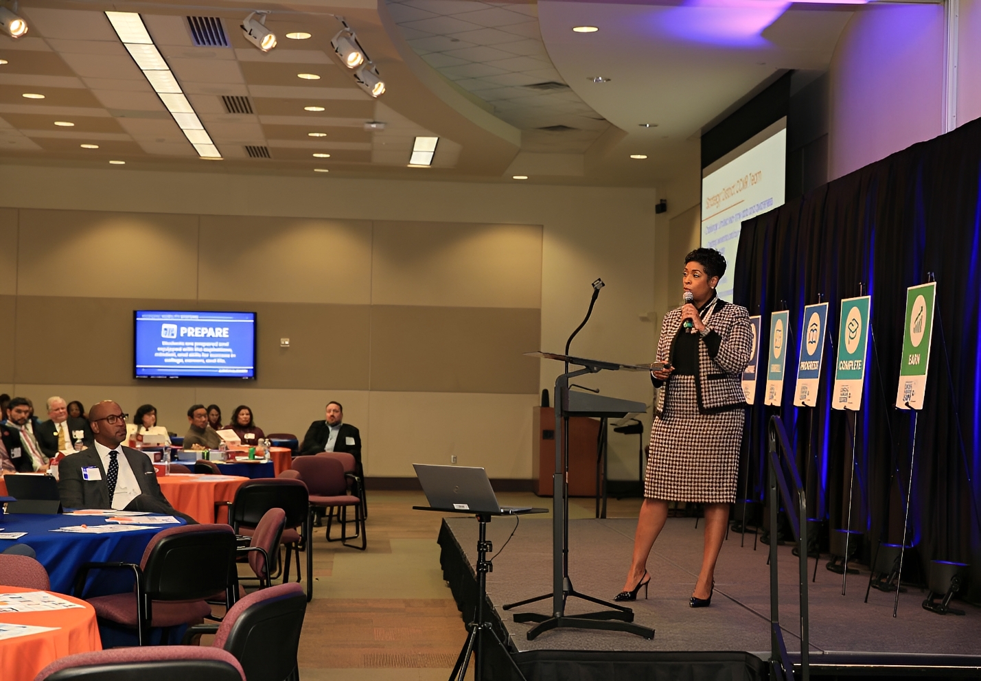 Woman speaking at a professional conference.